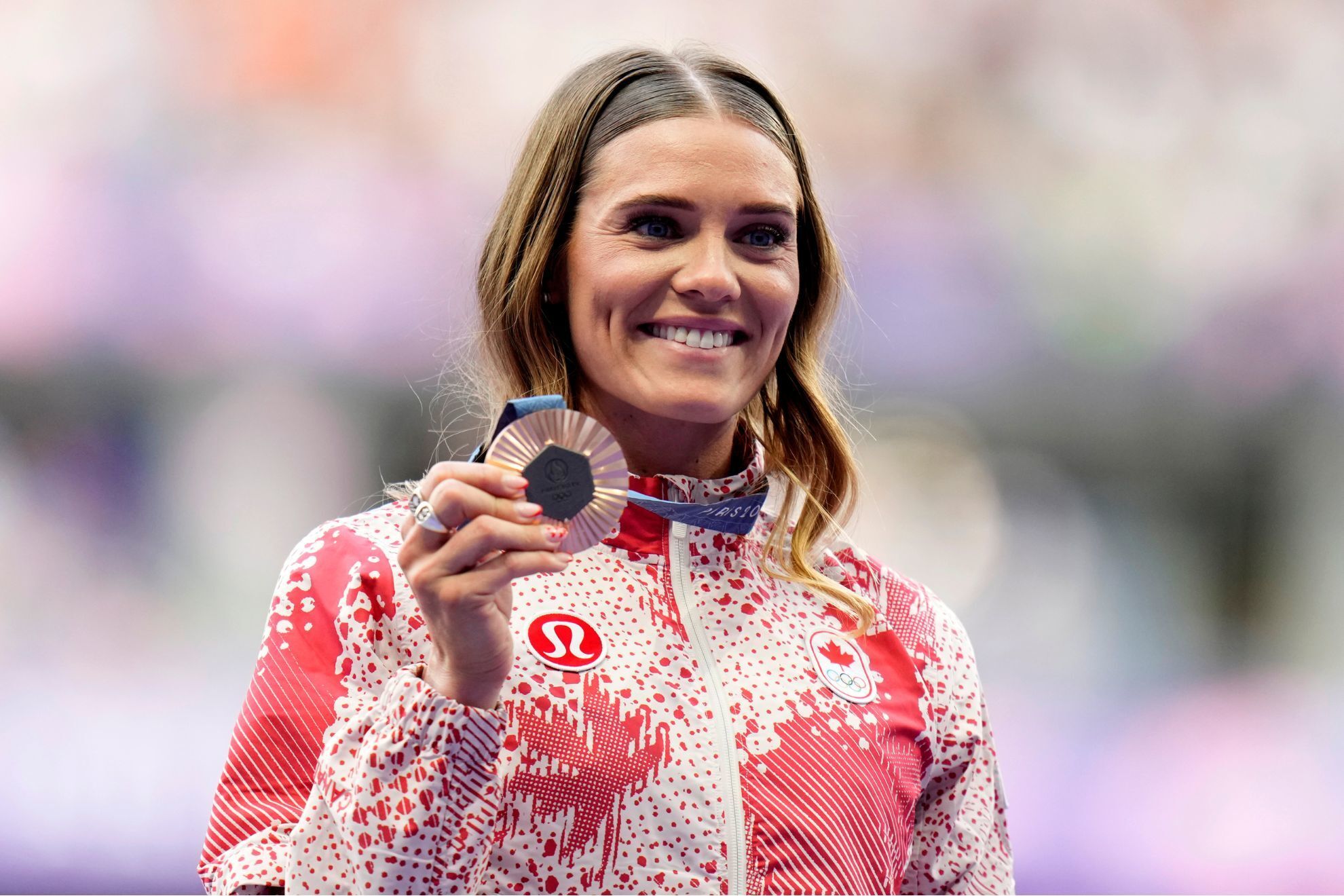 Womens pole-vault bronze medalist, Alysha Newman, of Canada, poses for a photo on the podium at the 2024 Summer Olympics